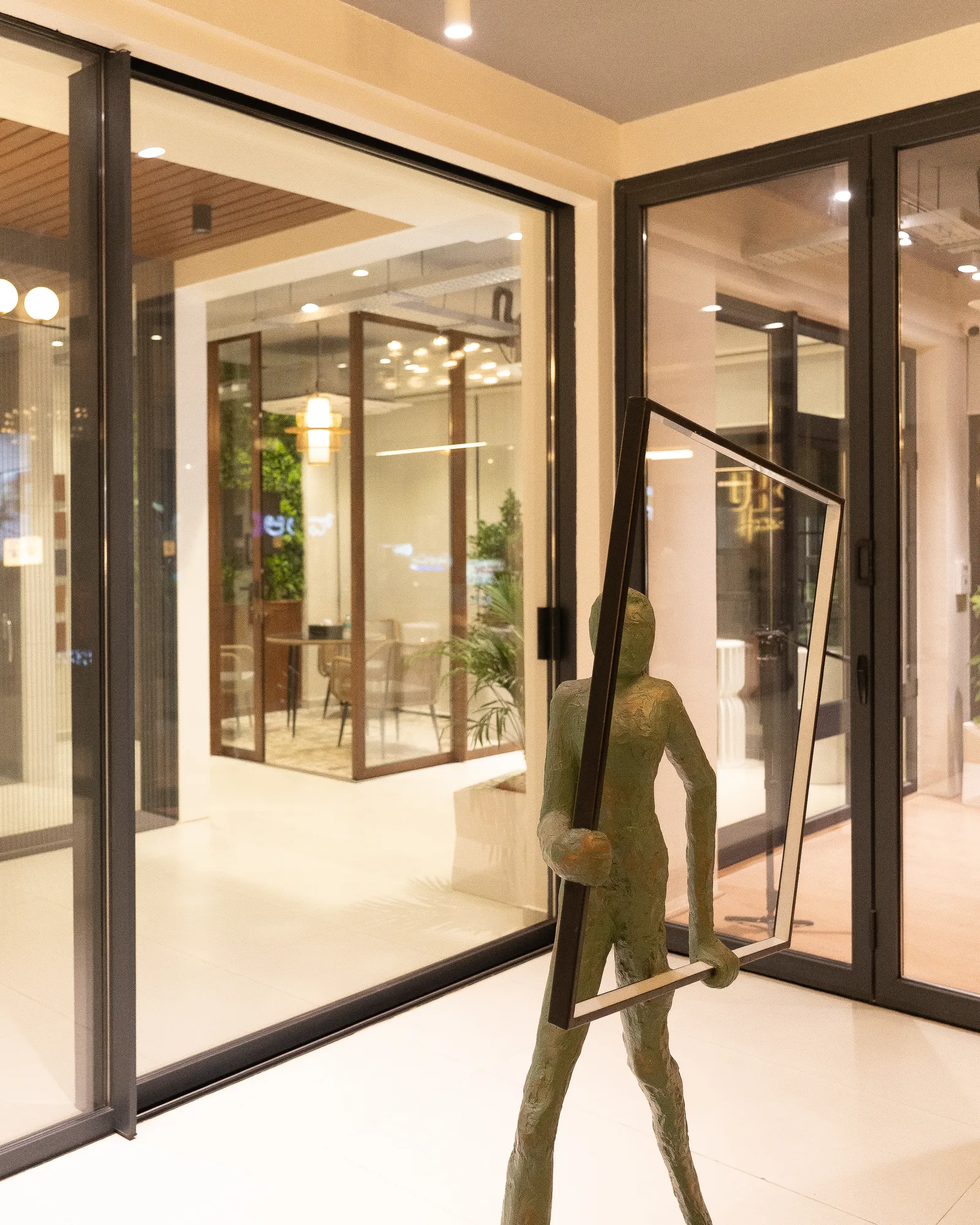 Showroom entrance with aluminium glass doors and sculpture — Aluk Experience Center